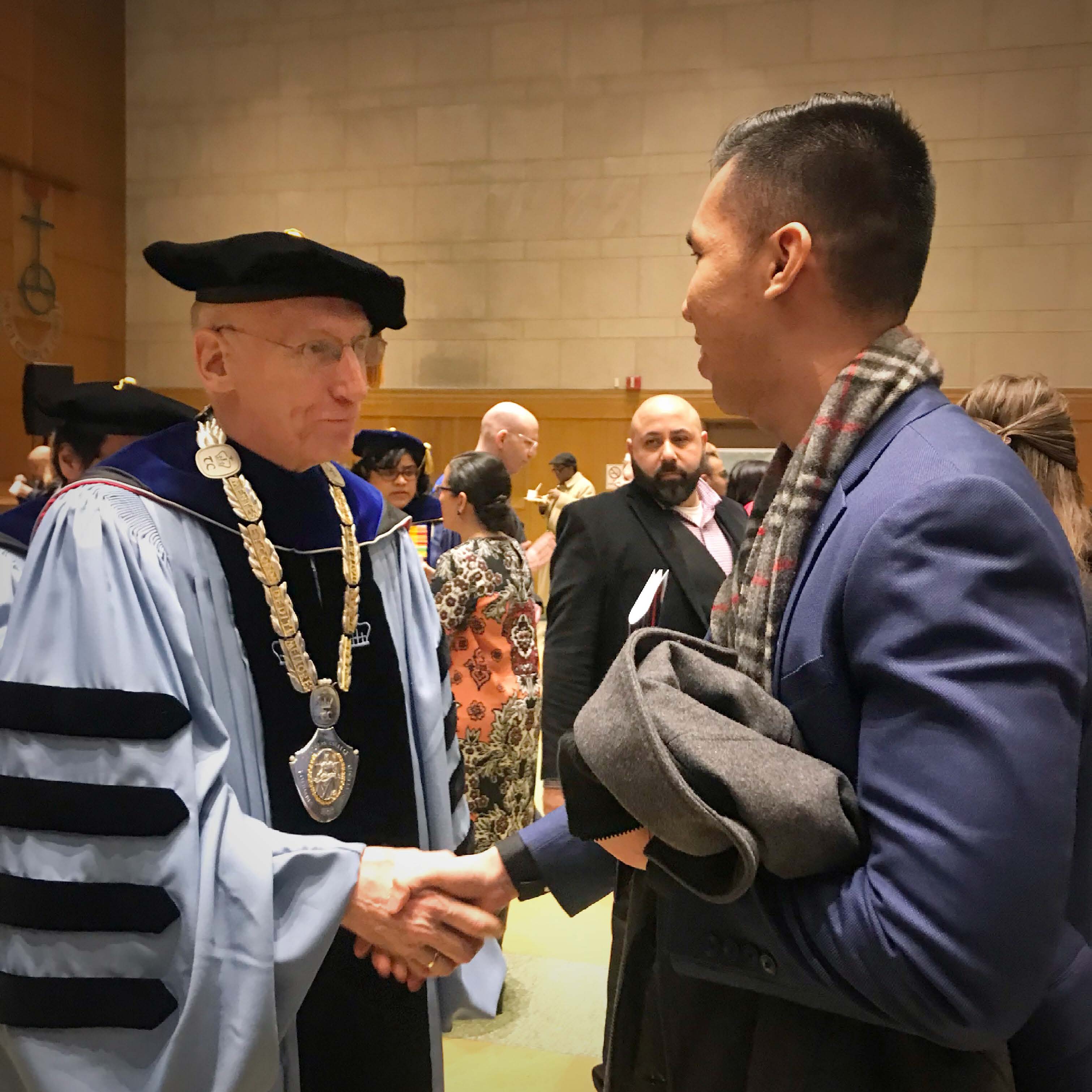 Minh Le greeting Dr. Thomas Bailey, President of Teachers College