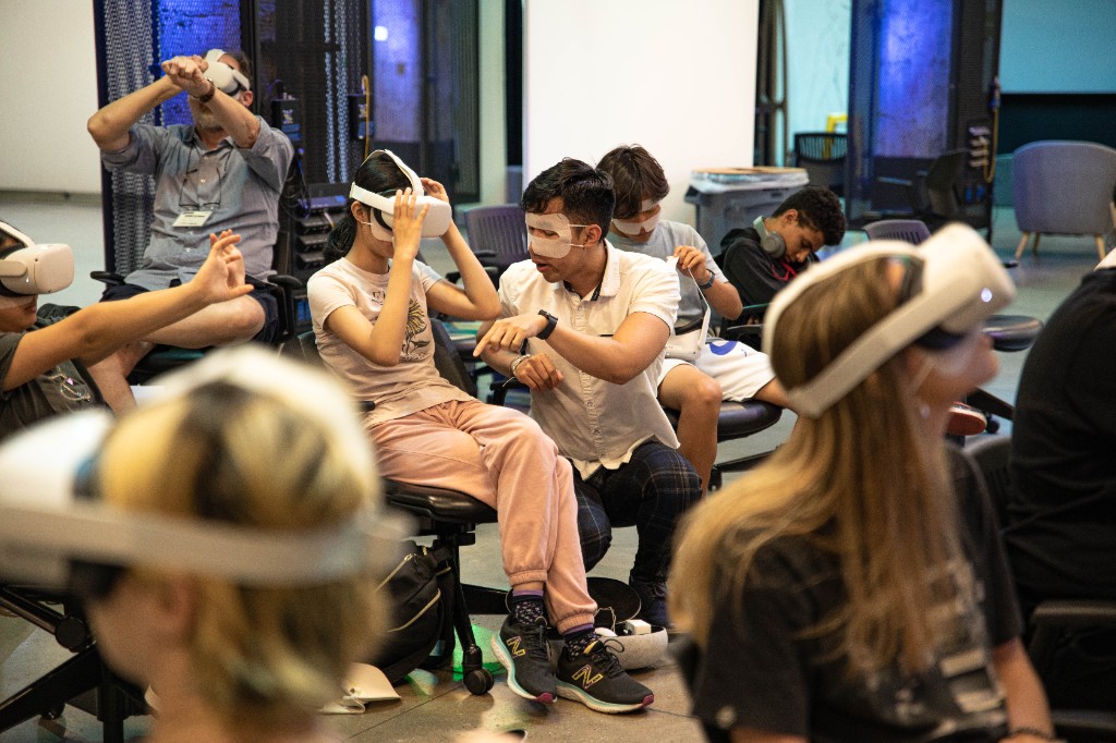 Teachers wearing VR headsets during a guided Literacy Unbound session