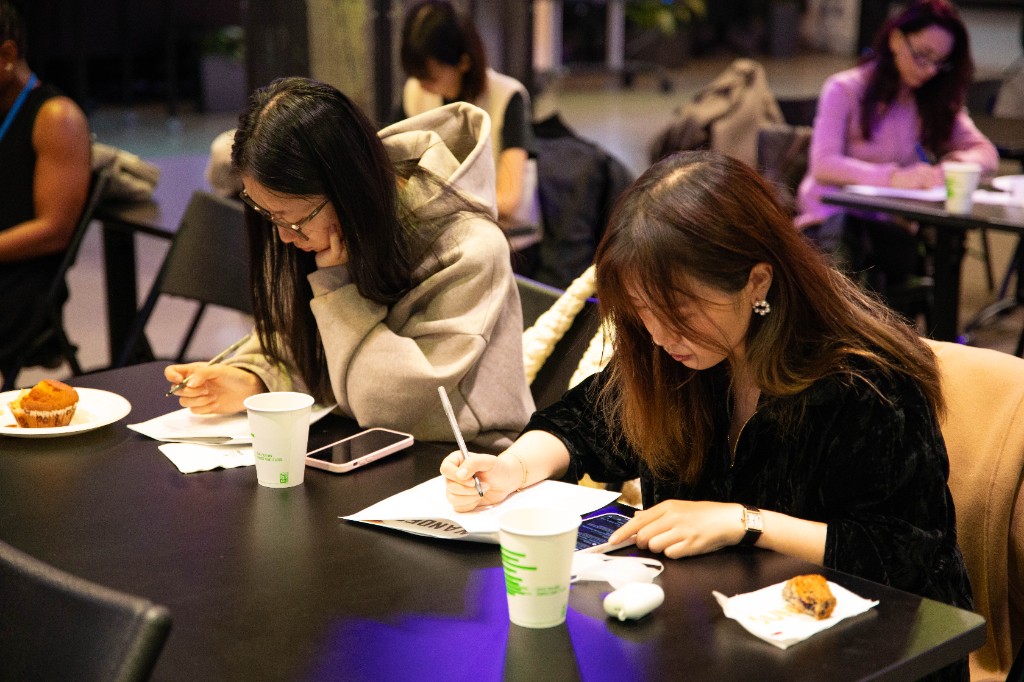 Participants writing and reflecting during a TST workshop session